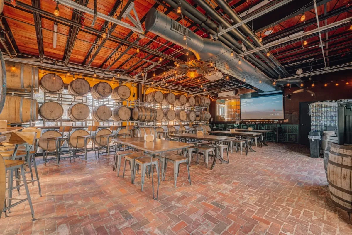Communal tables beneath timber beams at Lazarus Brewing’s East Sixth location in Austin